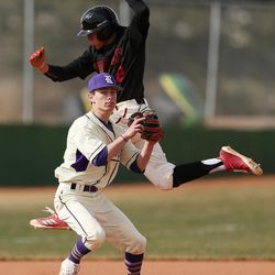 American Fork's Jack Walker tries to avoid the tag by Riverton's  Buddy Young in American Fork on Wednesday, March 21, 2018.