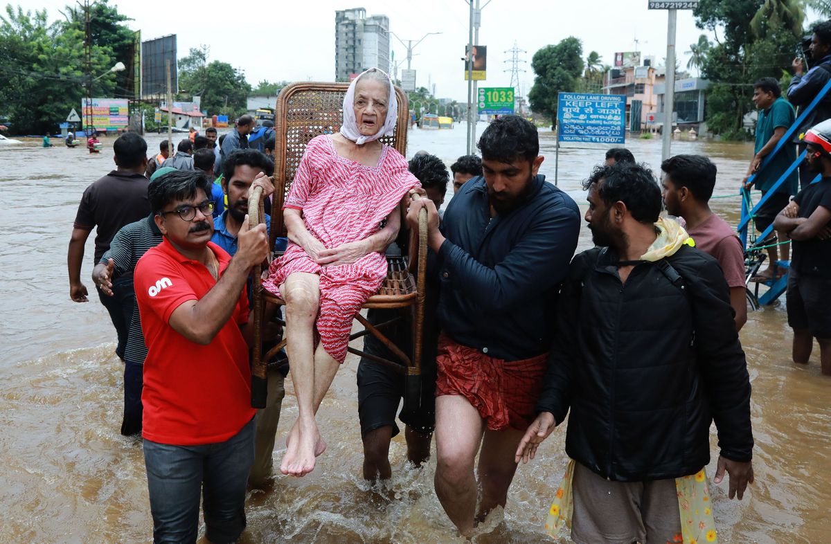 Indian volunteers and rescuers evacuate local residents from the flood-stricken state of Kerala in India on August 17, 2018.