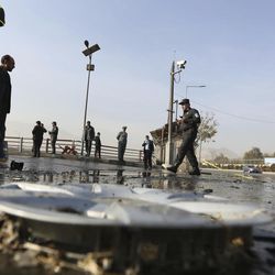 Afghan security forces inspect the site of a suicide attack in Kabul, Afghanistan, Wednesday, Nov. 16, 2016. A suicide bomber on a motorbike attacked a vehicle of the security forces on Wednesday in the capital Kabul, security officials said. 