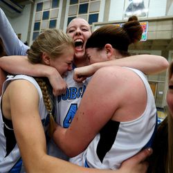 Sky View's Abby Harper, left, Hannah Monson and Hunter Krebs celebrate after winning the 4A championship game against Skyline at Salt Lake Community College Saturday, Feb. 21, 2015. The Bobcats beat the Eagles, 43-32.