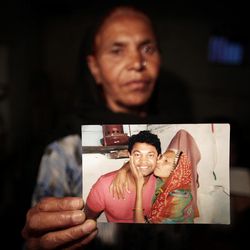 Fatima Munshi, mother of Saroo, holds up a photo from their reunion at her home in Khandwa, India.
