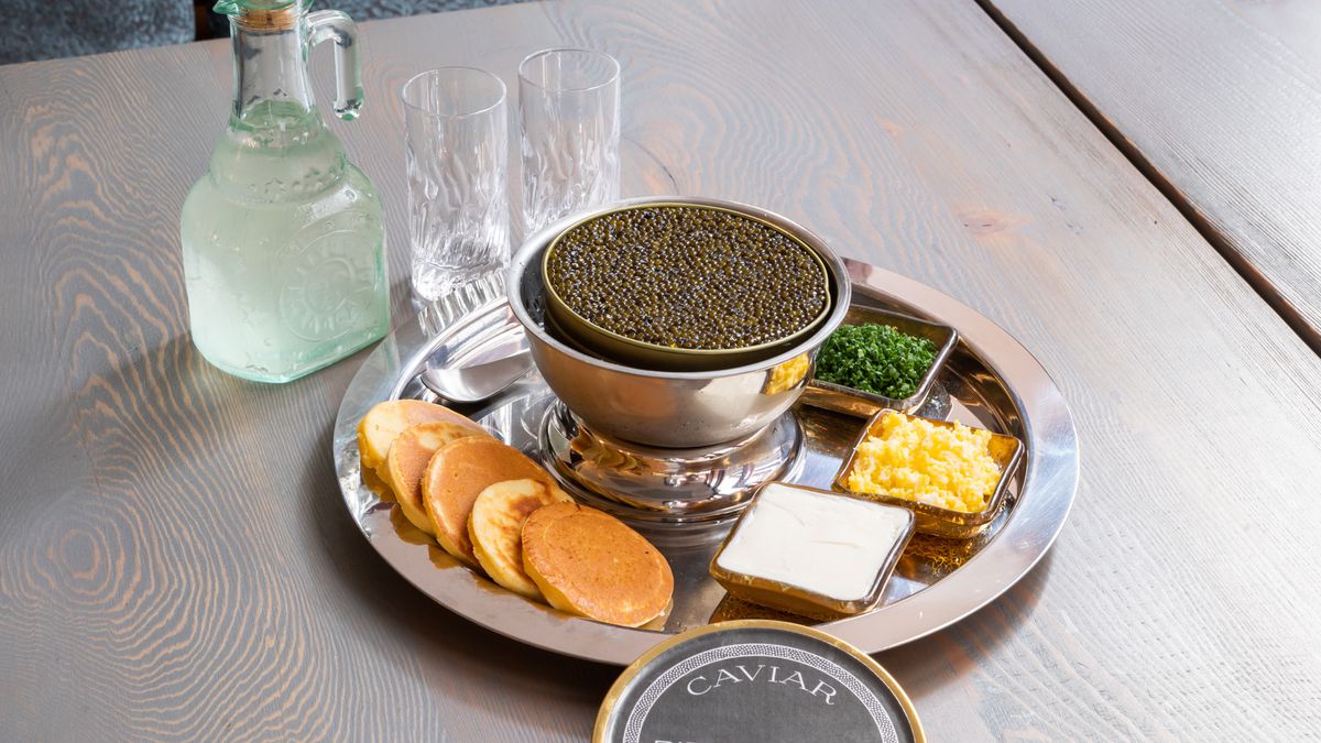 Caviar service, einkorn blinis, smetana, sieved egg, chives.