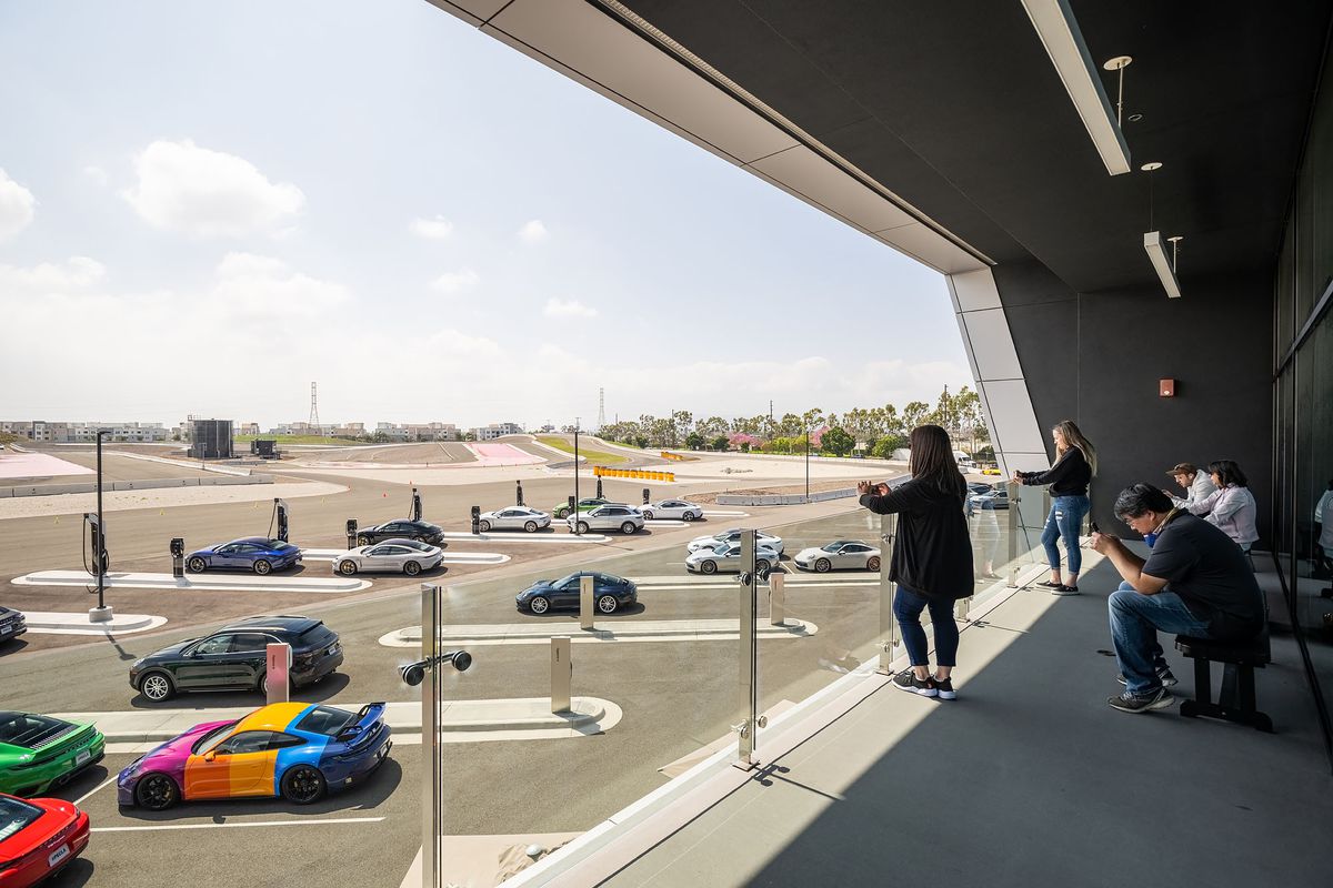 Spectators on the balcony at Restaurant 917 at Porsche Experience Center in Los Angeles.