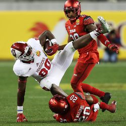 Utah Utes defensive back Marcus Williams (20) brings down Indiana Hoosiers tight end Ian Thomas (80) as the Utes and the Hoosiers play in the Foster Farms Bowl in Santa Clara, California, on Wednesday, Dec. 28, 2016.