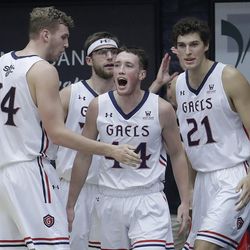 Saint Mary's guard Cullen Neal, center, celebrates with Jock Landale (34), Evan Fitzner (21) and forward Calvin Hermanson, rear, after Neal scored during the first half of an NCAA college basketball game against BYU in Moraga, Calif., Thursday, Jan. 25, 2018. (AP Photo/Jeff Chiu)