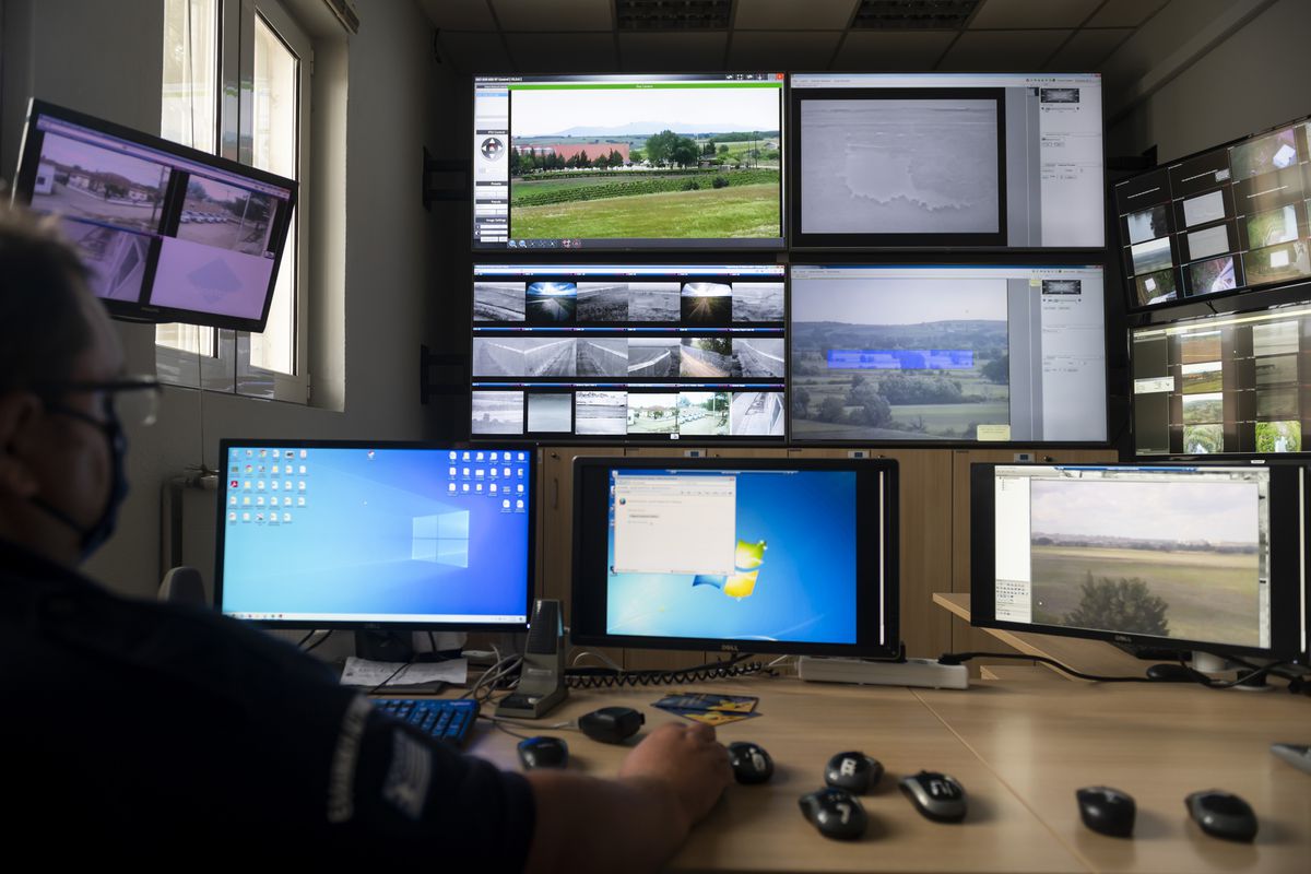 A police officer works inside the operation center at the village of Nea Vyssa near the Greek - Turkish border, Greece, Friday, May 21, 2021.