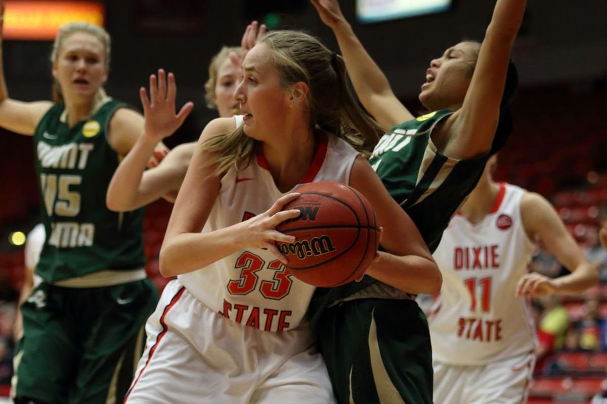 Dixie State senior Taylor Mann (center) looks to pass vs. Point Loma on Jan. 18. Mann was named to the D2CAA All-West Region Second Team on Monday. 