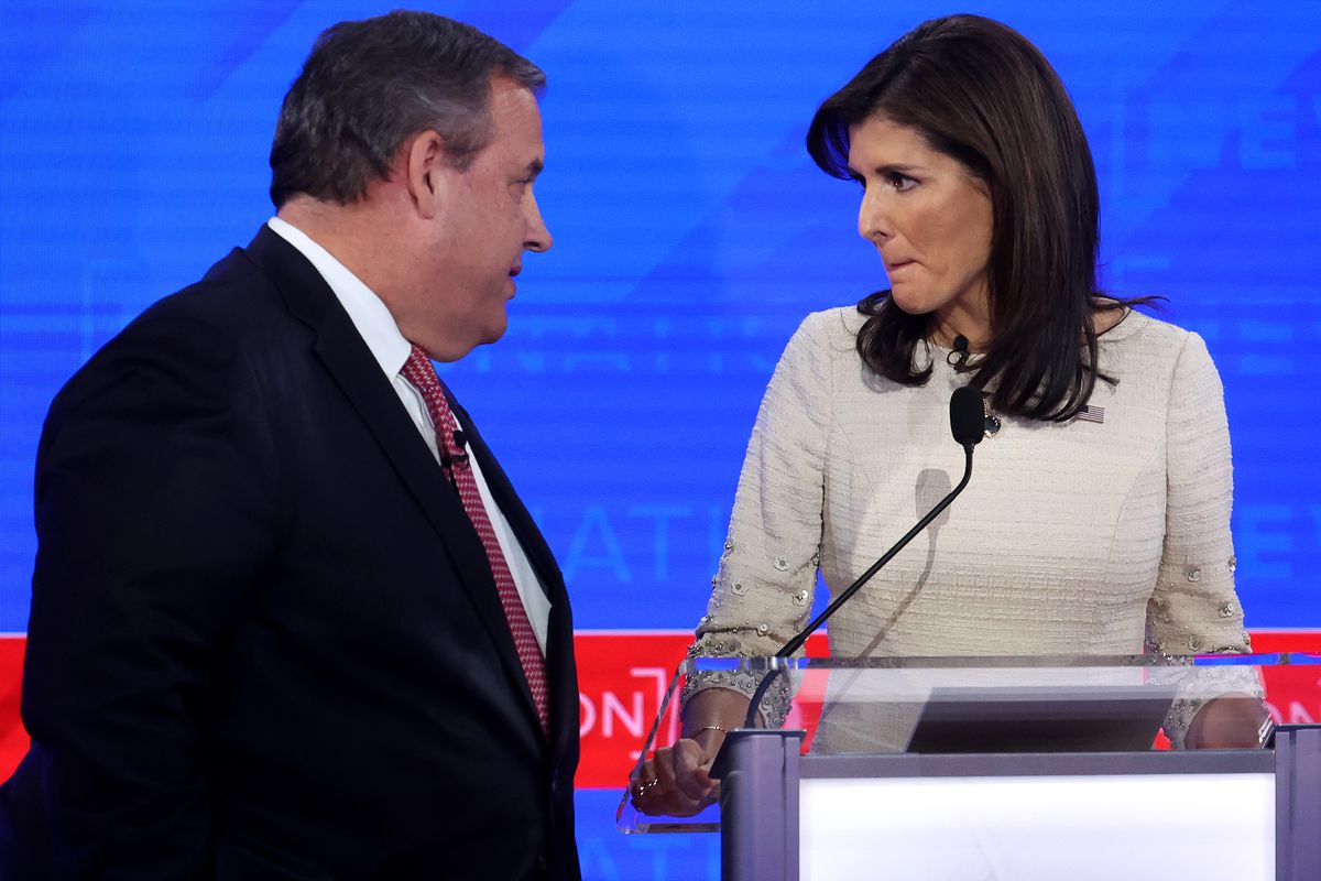 Christie and Haley face each other, against a blue backdrop.