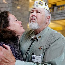Hannah Gutzner embraces her husband George during the 3rd annual State of Utah Vietnam Veterans Recognition Day at the Capitol in Salt Lake City Tuesday, March 29,  2016.