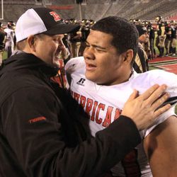 Hurricane High athletic director Chris Homer cheers on player James Rossi after the winning the 3AA semifinal high school football game against Desert Hills in the Rice-Eccles Stadium Friday, Nov. 14, 2014, Salt Lake City.