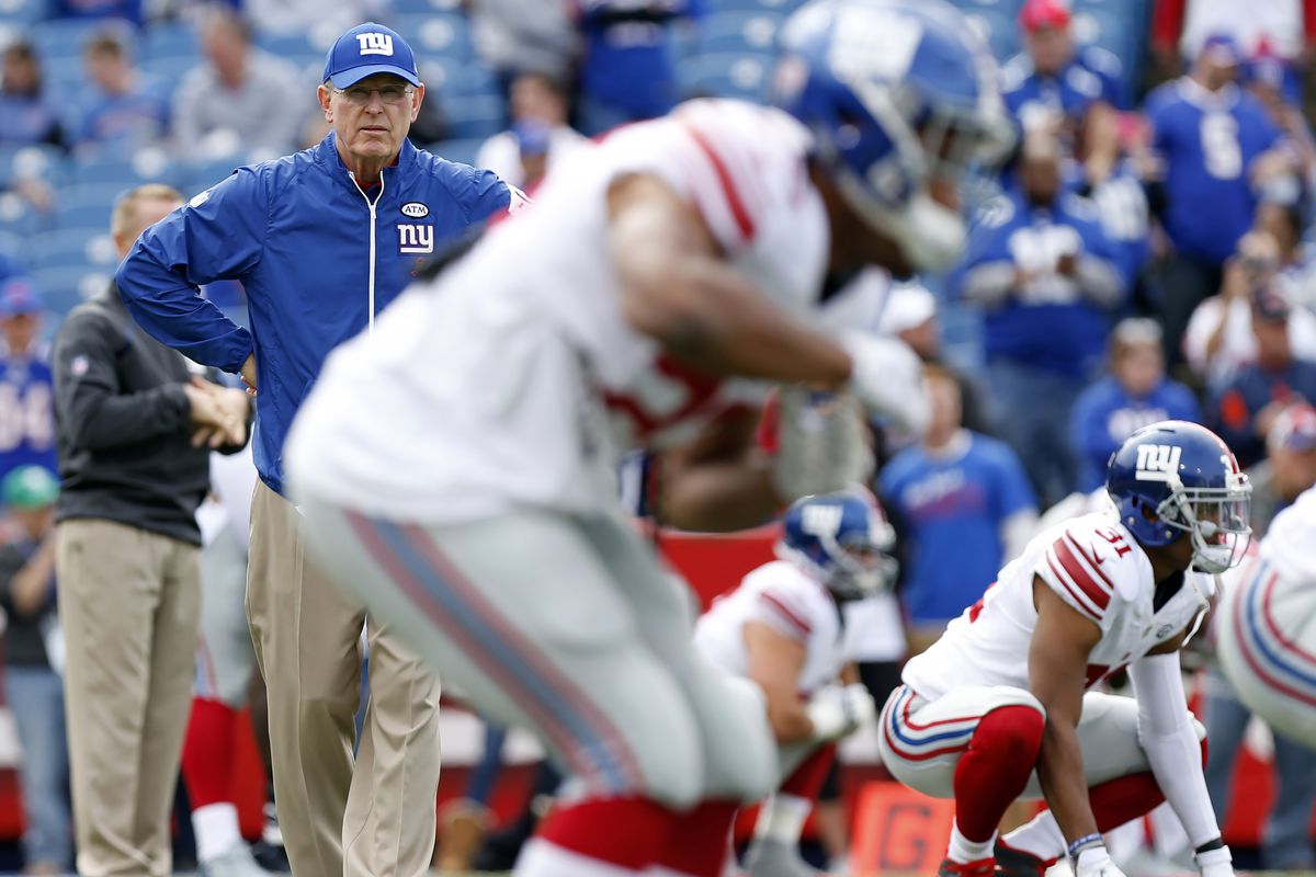 Tom Coughlin watches the Giants arm up on Sunday