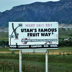 A sign along I-15 directs drivers to Utah's Famous Fruit Way in Box Elder County.