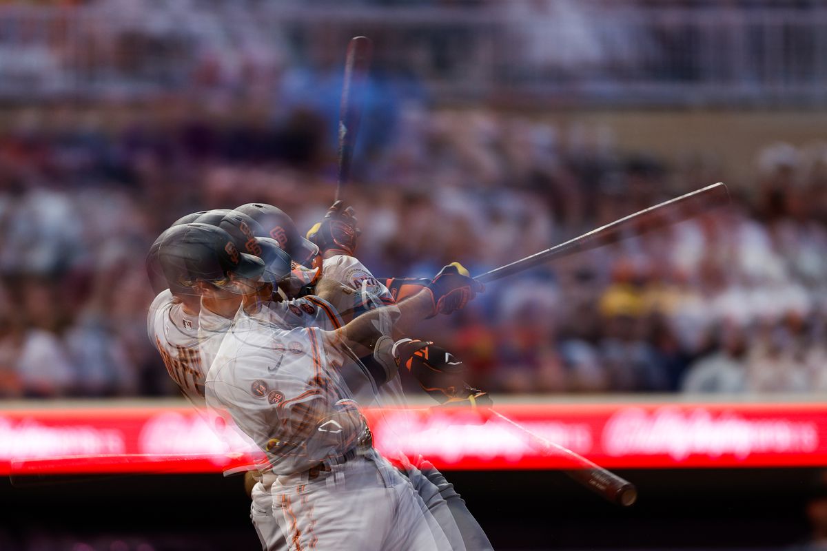 Multiple exposures show a time lapse of Casey Schmitt swinging a bat