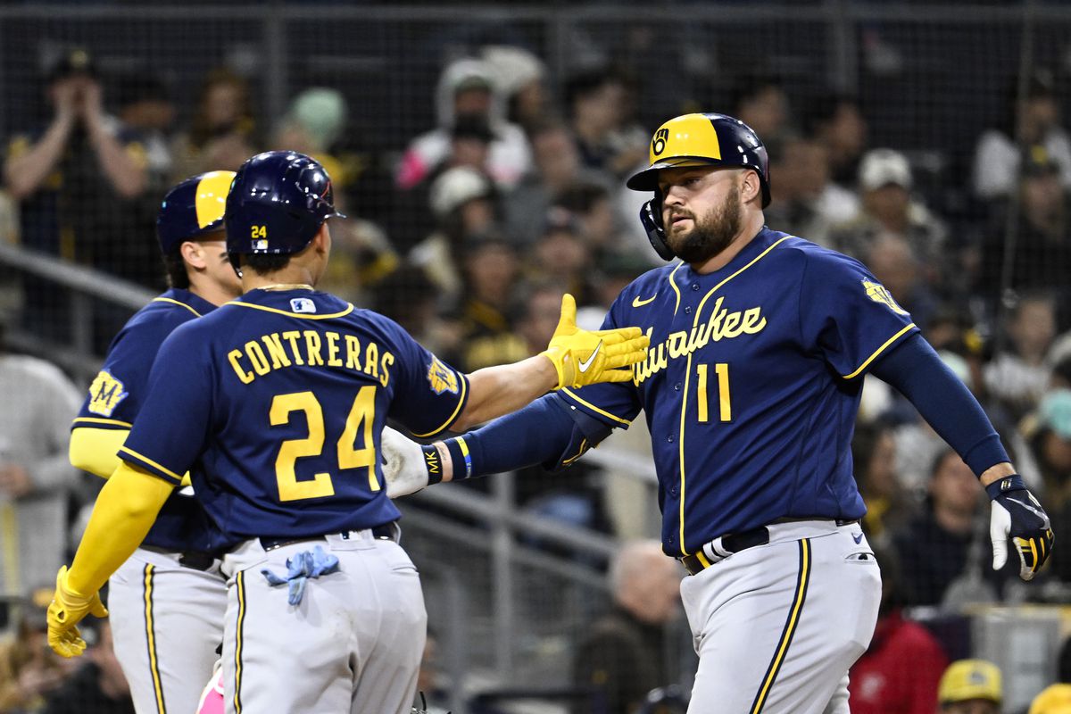 Rowdy Tellez of the Milwaukee Brewers is congratulated by William Contreras after hitting a three-run home run during the sixth inning of a baseball game against the San Diego Padres April 14, 2023 at Petco Park in San Diego, California.  