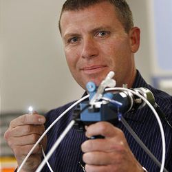 Tim Nieman, holds the Veritract Smart Tube, a fiber optic device that helps place a feeding tube in patiences, started at the University of Utah through the university's tech startup program Wednesday, Nov. 30, 2011, in Salt Lake City, Utah.   
