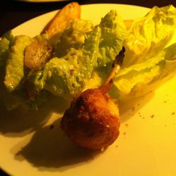 The chicken Kiev Caesar salad, which was plated piece by piece.  The lady got two chicken lollipops, the gentleman received just one. 