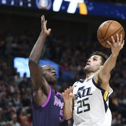 Utah Jazz guard Raul Neto (25) jumps to score while guarded by Minnesota Timberwolves center Gorgui Dieng (5) at Vivint Arena in Salt Lake City on Thursday, March 14, 2019.
