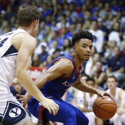 Kansas guard Devon Dotson (1) tries to get around BYU guard Connor Harding (44) during the first half of an NCAA college basketball game Tuesday, Nov. 26, 2019, in Lahaina, Hawaii. 