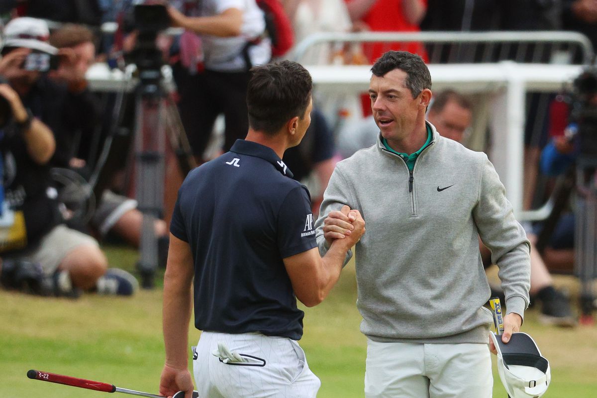 Viktor Hovland of Norway and Rory McIlroy of Northern Ireland shake hands on the 18th green during Day Three of The 150th Open at St Andrews Old Course on July 16, 2022 in St Andrews, Scotland.