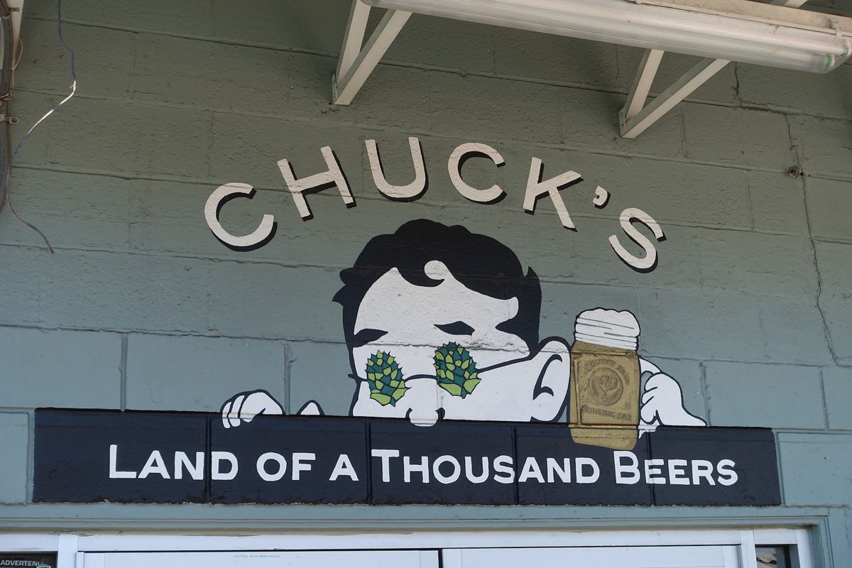 The mural at Chuck’s Hop Shop which has a drawing of a man wearing glasses with hops on them while holding a beer; below it says “Land of a Thousand Beers”