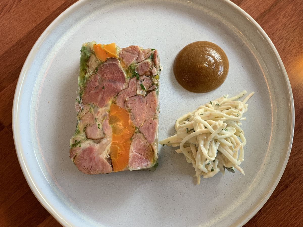 A smoked ham terrine served with apple puree and a celeriac and apple slaw.