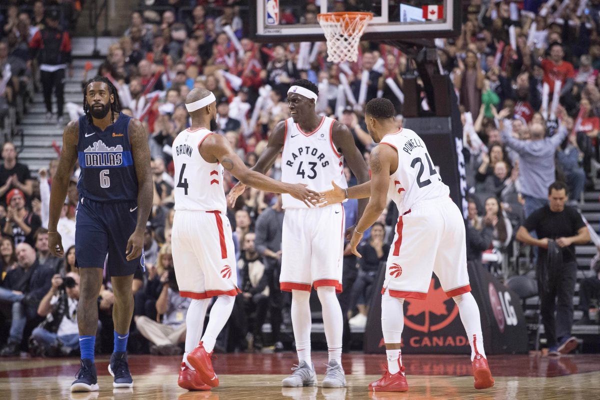 Toronto Raptors guard Lorenzo Brown celebrates scoring a basket with forward Pascal Siakam and forward Norman Powell during the fourth quarter against the Dallas Mavericks at Scotiabank Arena.