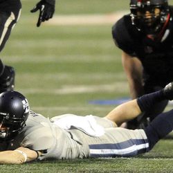 Utah State Aggies wide receiver Travis Van Leeuwen (7) stretches out for yardage after a catch during the Mountain West football championship game at Bulldog Stadium in Fresno, Calif., on Saturday, Dec. 7, 2013.