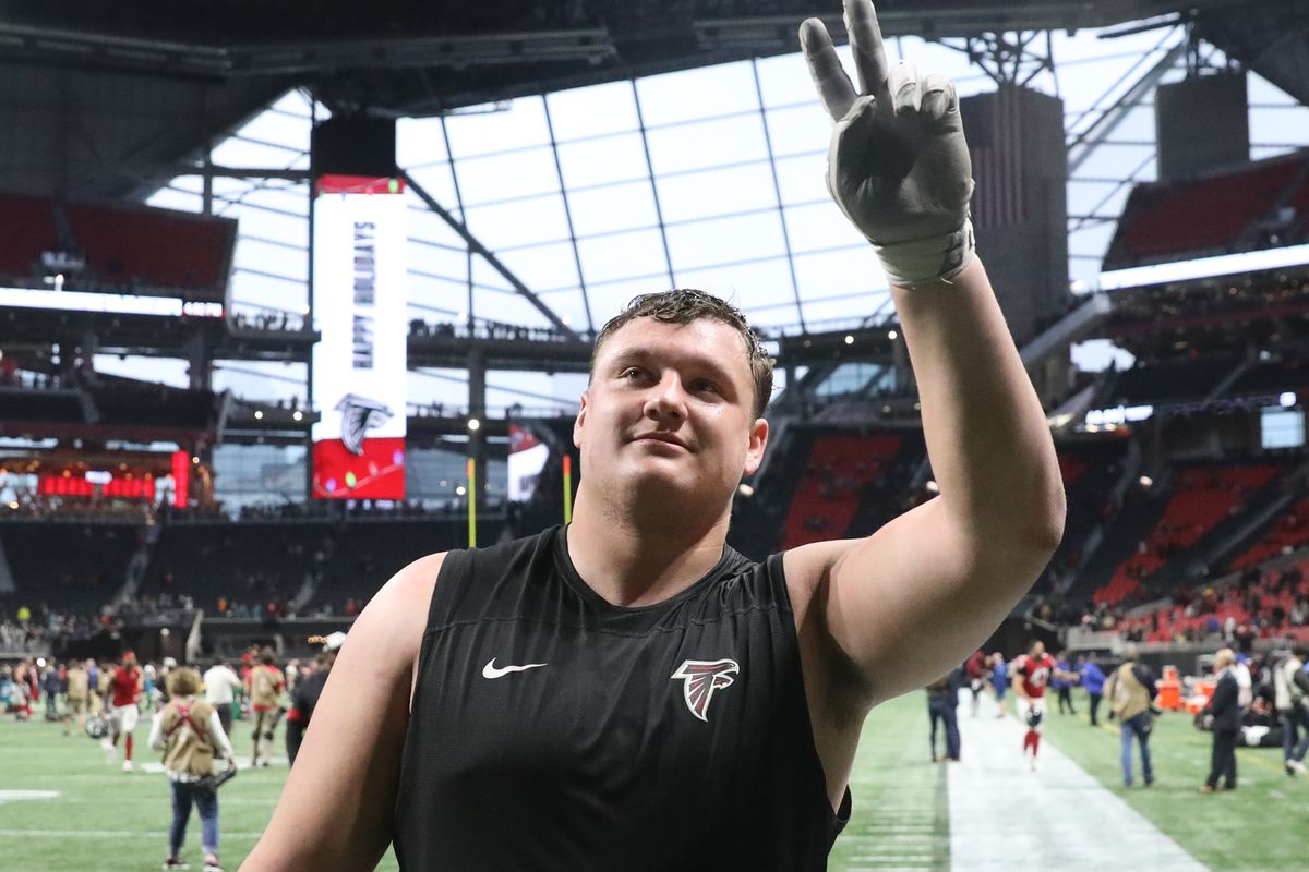 Falcons guard Chris Lindstrom smiles and acknowledges fans after a game in Mercedes-Benz Stadium.