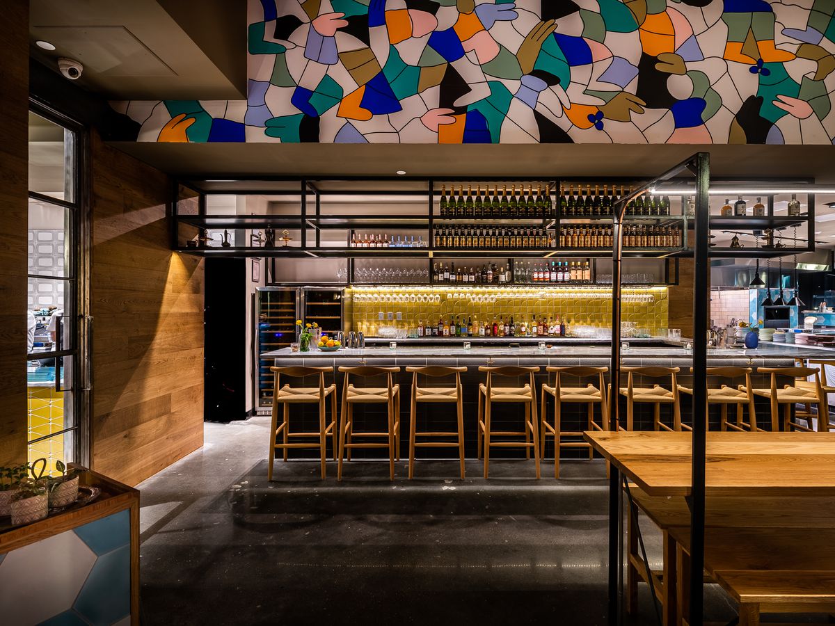 The bar at Albi sits underneath one end of a colorful 50-foot mural