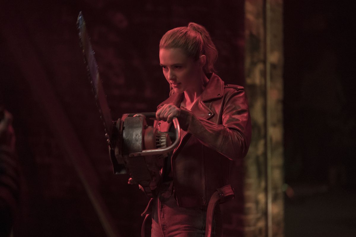 Illuminated entirely in red, Freaky star Kathryn Newton swings a chainsaw