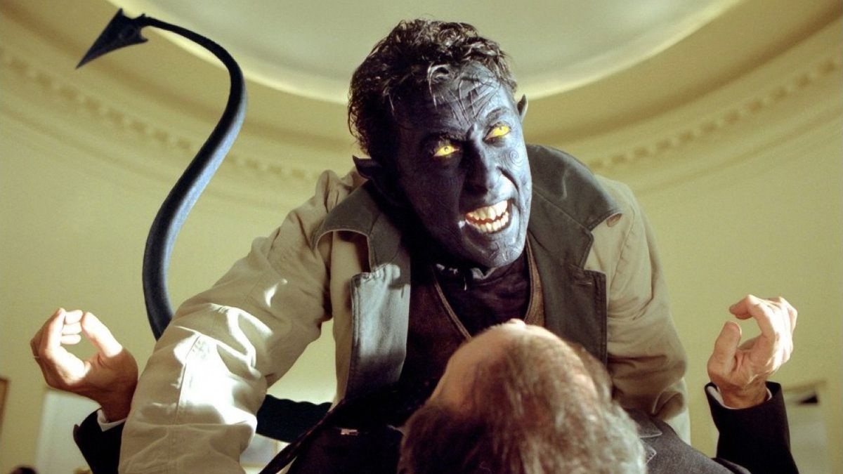 Alan Cumming as Nightcrawler, a blue-skinned, yellow-eyed mutant with a spade-tipped tail, pins the president of the United States to his Oval Office desk and hisses in his face in X2: X-Men United