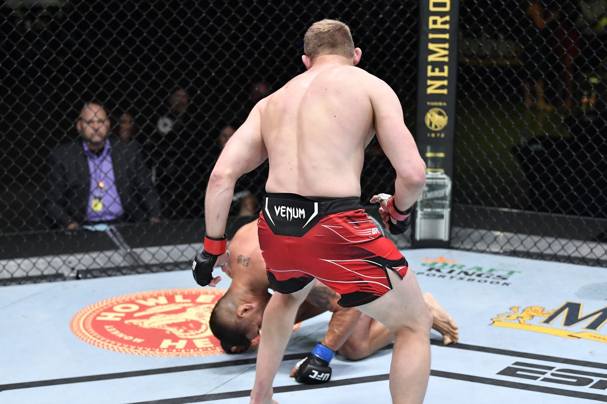 Marcin Prachnio of Poland drops Ike Villanueva with a body kick in a light heavyweight fight during the UFC Fight Night event at UFC APEX on June 26, 2021 in Las Vegas, Nevada.