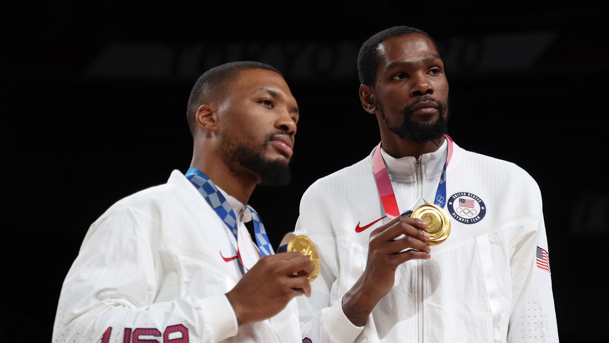 Damian Lillard and Kevin Durant pose for photographs with their gold medals during the Men’s Basketball medal ceremony on day fifteen of the Tokyo 2020 Olympic Games at Saitama Super Arena on August 07, 2021 in Saitama, Japan.