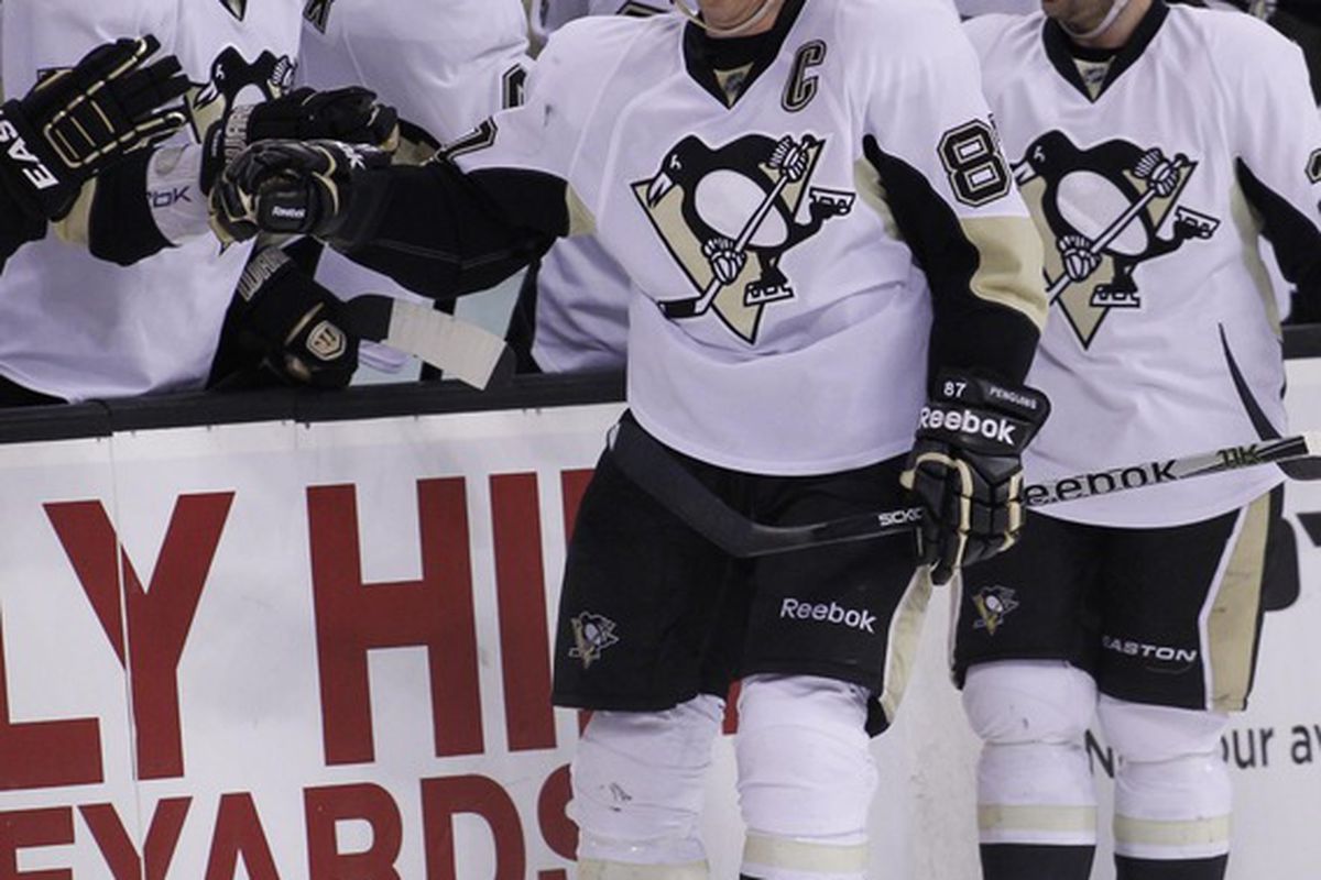 April 3, 2012; Boston, Massachusetts, USA; Pittsburgh Penguins center Sidney Crosby (87) skates past the bench after a goal during the second period against the Boston Bruins at TD Banknorth Garden.  Mandatory Credit: Greg M. Cooper-US PRESSWIRE