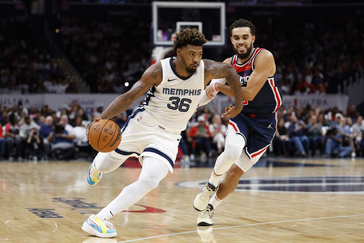 Memphis Grizzlies guard Marcus Smart (36) dribbles the ball past Washington Wizards guard Tyus Jones (5) in the fourth quarter at Capital One Arena.