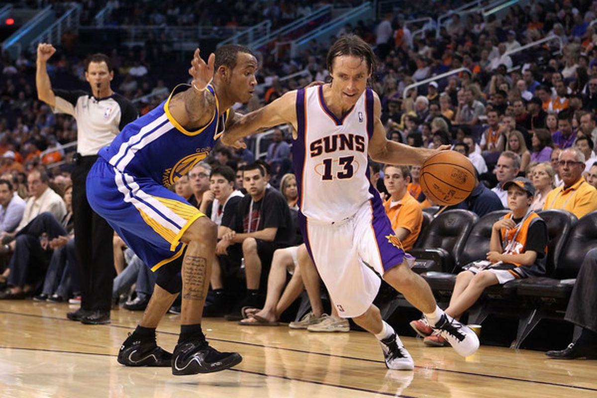 PHOENIX - OCTOBER 19:  Steve Nash #13 of the Phoenix Suns drives the ball past Monta Ellis #8 of the Golden State Warriors  (Photo by Christian Petersen/Getty Images)