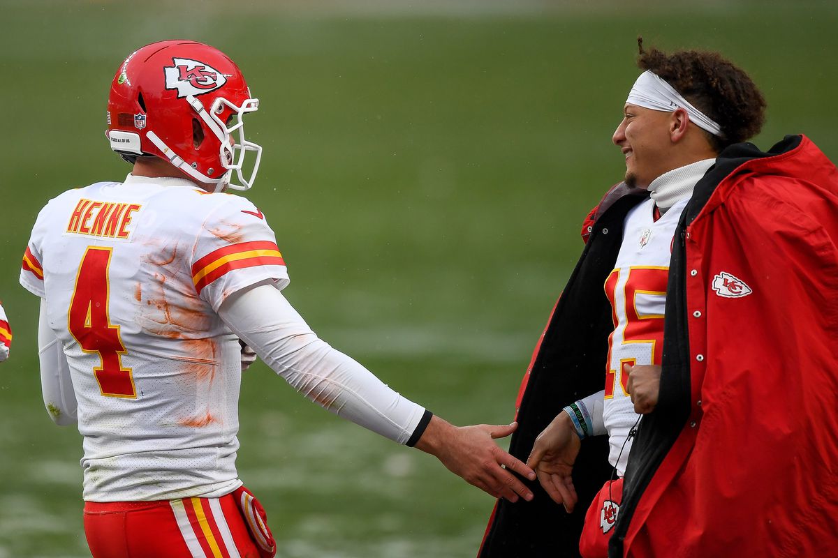 Chad Henne #4 of the Kansas City Chiefs is congratulated by Patrick Mahomes #15 after scoring a rushing touchdown against the Denver Broncos at Empower Field at Mile High on October 25, 2020 in Denver, Colorado.