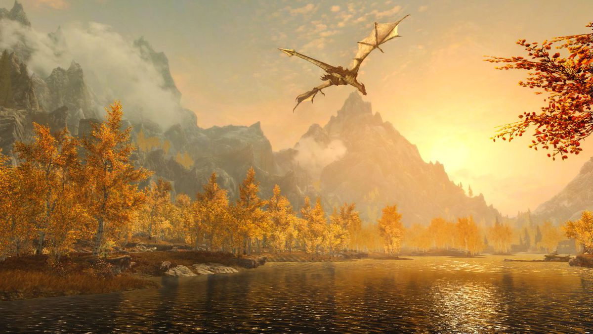 A dragon flies above an autumnal forest bisected by a glistening river at dawn in The Elder Scrolls 5: Skyrim Special Edition