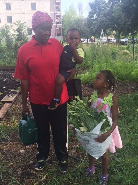 Martha Itulya-Omollo shown with her children. | Photo provided by 65th &amp; Woodlawn Garden Committee