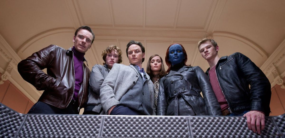 Magneto (Michael Fassbender), Banshee (Caleb Landry Jones), Professor X (James McAvoy), Moira MacTaggert (Rose Byrne), Mystique (Jennifer Lawrence), and Havok (Lucas Till), all in civilian clothing, stand on a balcony together, looking down at the camera, in X-Men: First Class