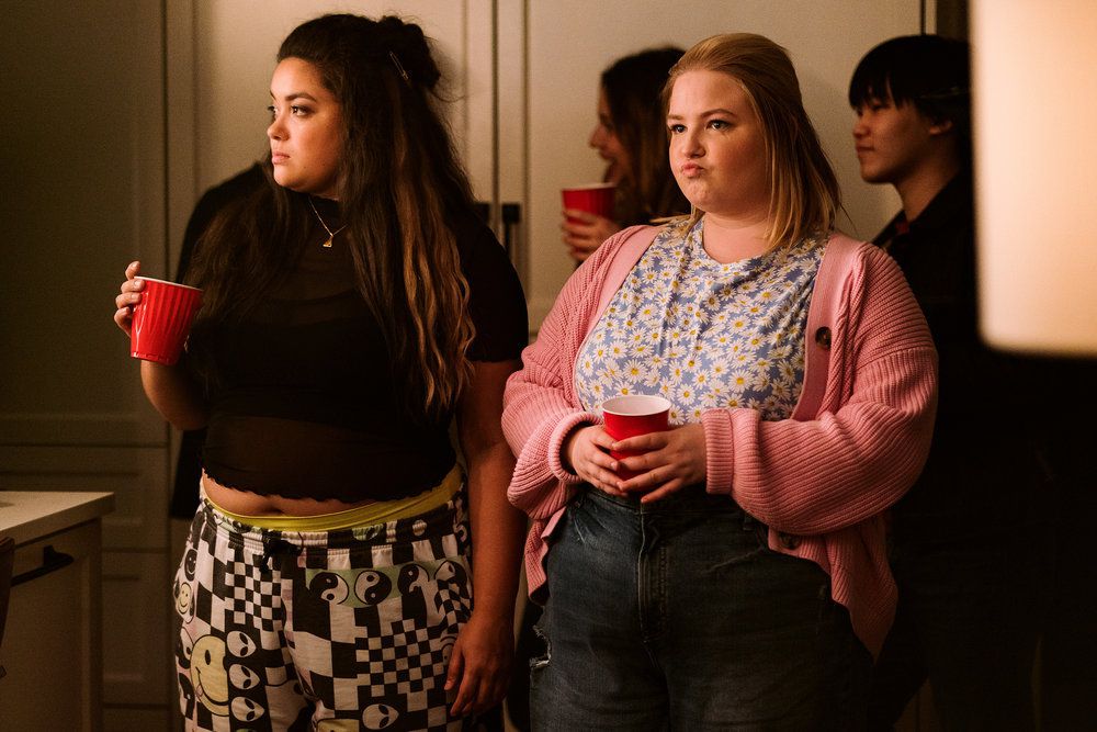 astrid and lilly standing at a party 