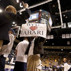 A fan holds up a sign encouraging high school standout Jabari Parker to attend BYU before the NCAA basketball game between BYU and Cal State Northridge, Saturday, Nov. 24, 2012.