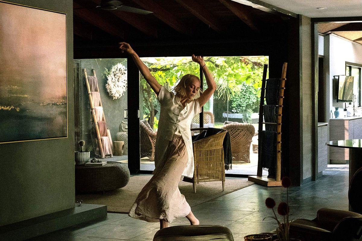 Dressed in white, Jena Malone dances in an otherwise empty house.