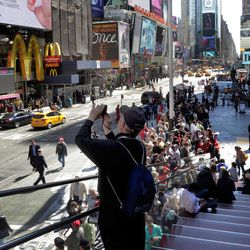A man takes a photo in New York's Times Square, Thursday, April 25, 2013. The Boston Marathon bombing suspects had planned to blow up their remaining explosives in New York's Times Square, officials said Thursday. 