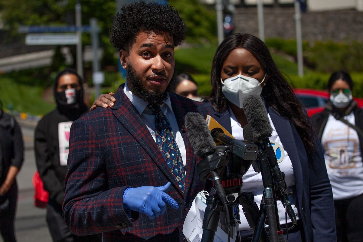 Bruce McIntyre speaks at a podium during a rally outside of Montifiore Medical Center on May 5, 2020, demanding the hospital be held accountable for the death of his partner, Amber Isaac.