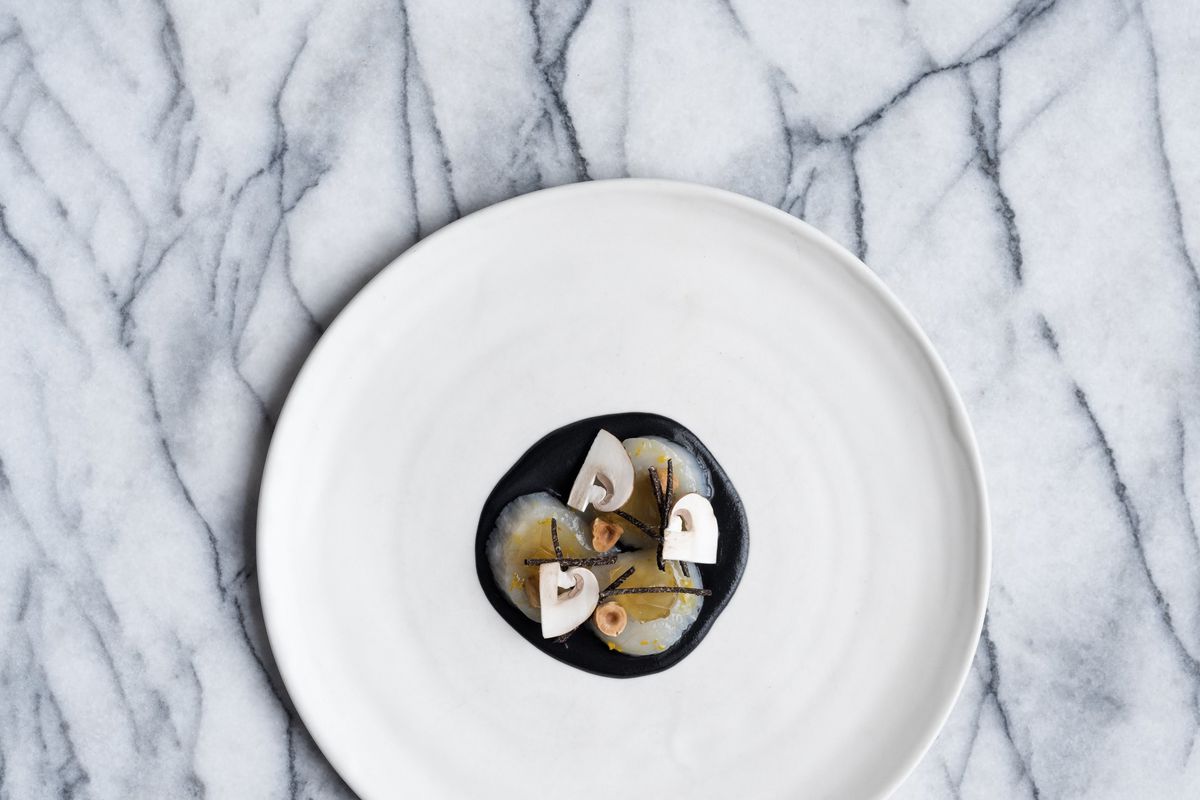 From above, a starkly plated modernist dish on a geometric background.