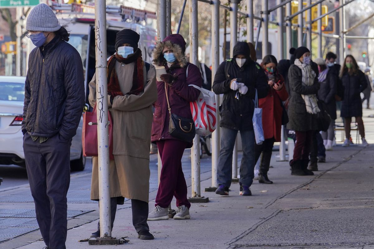 In this Nov. 18, 2020, file photo, people wait in a line stretching around a block, outside a CityMD urgent care clinic offering COVID-19 testing in the Park Slope neighborhood of the Brooklyn borough of New York.