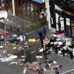 One of the blast sites on Boylston Street near the finish line of the 2013 Boston Marathon is seen in Boston, Tuesday, April 16, 2013, one day after bomb blasts killed three and injured over 140 people. FBI agents searched a suburban Boston apartment overnight and appealed to the public for amateur video and photos that might yield clues to who carried out the Boston Marathon bombing. 