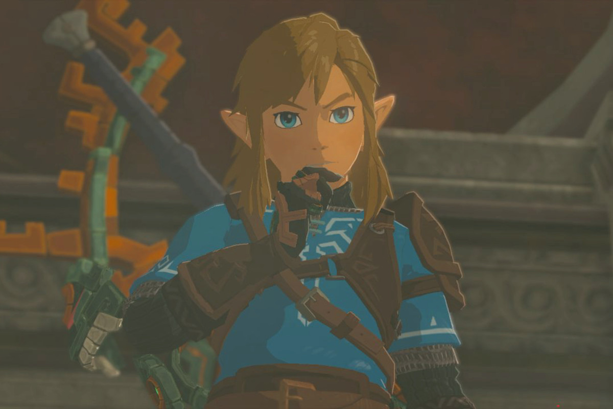Link wearing a blue tunic while rubbing his chin