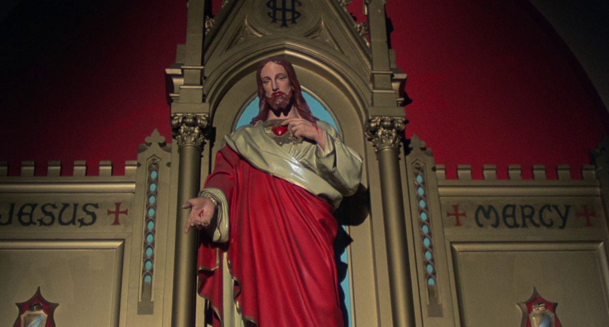 A statue of Jesus in a church from the movie God Told Me To